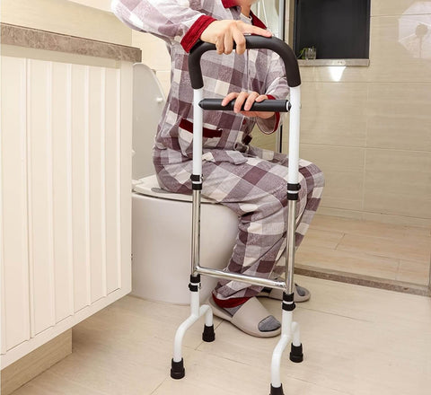 Person using a walker to get on a toilet in a bathroom.